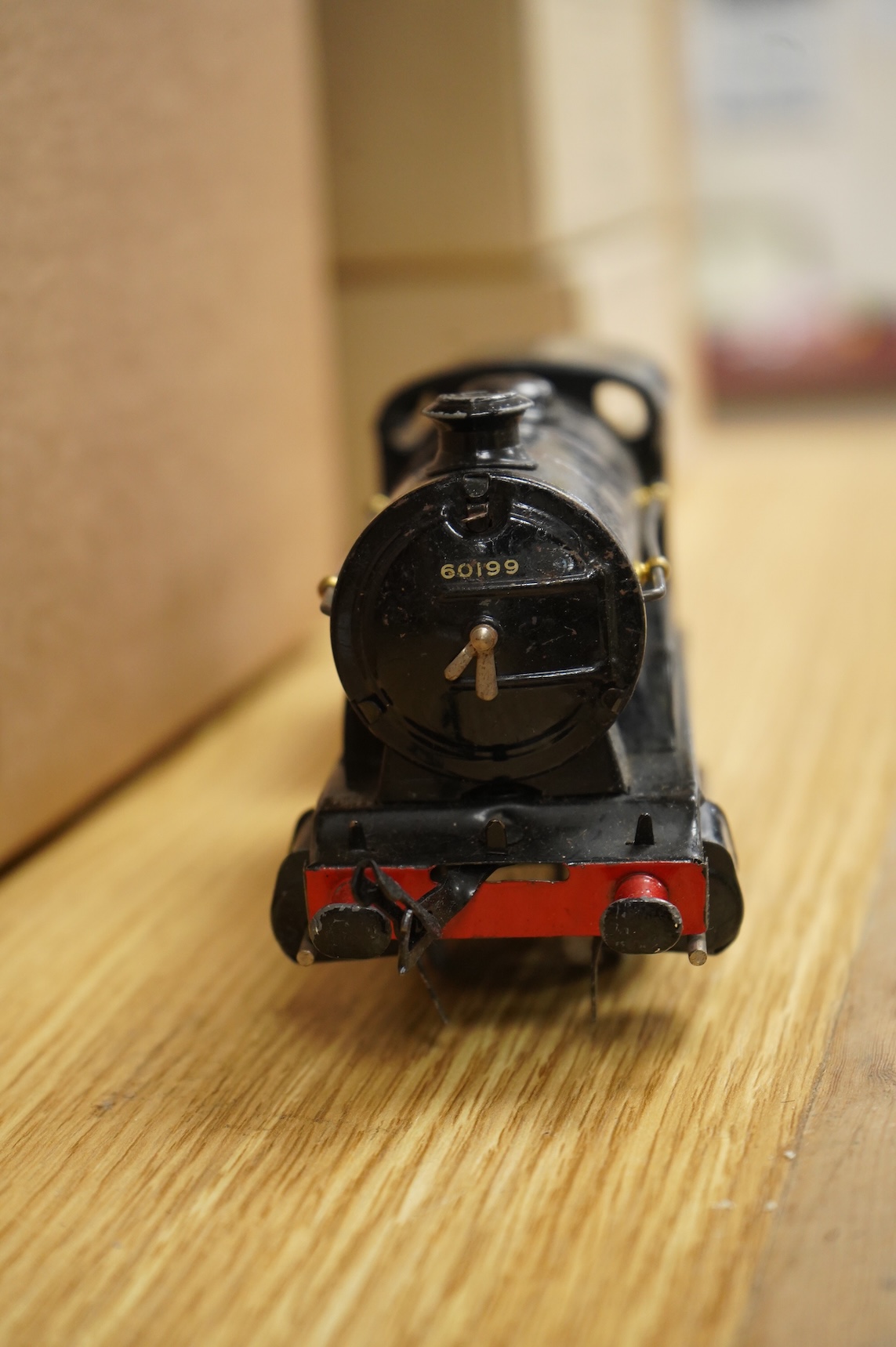 A collection of 0 gauge Hornby tinplate clockwork railway, including four BR locomotives, 17 freight wagons and four wheel coaches, together with a station building, signal cabin, and Goods depot (missing base), plus a f